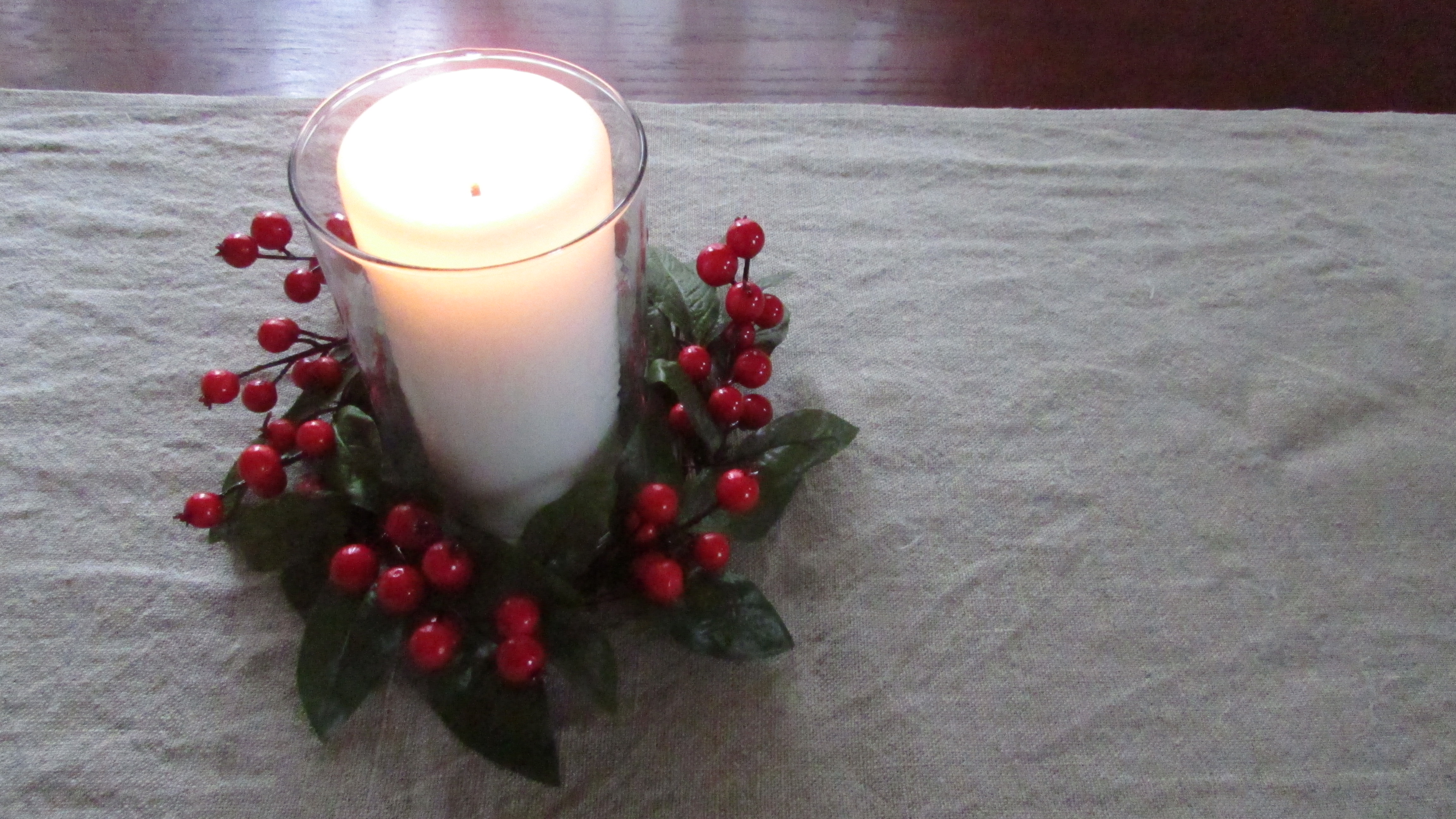 Red and green candle ring with lit candle