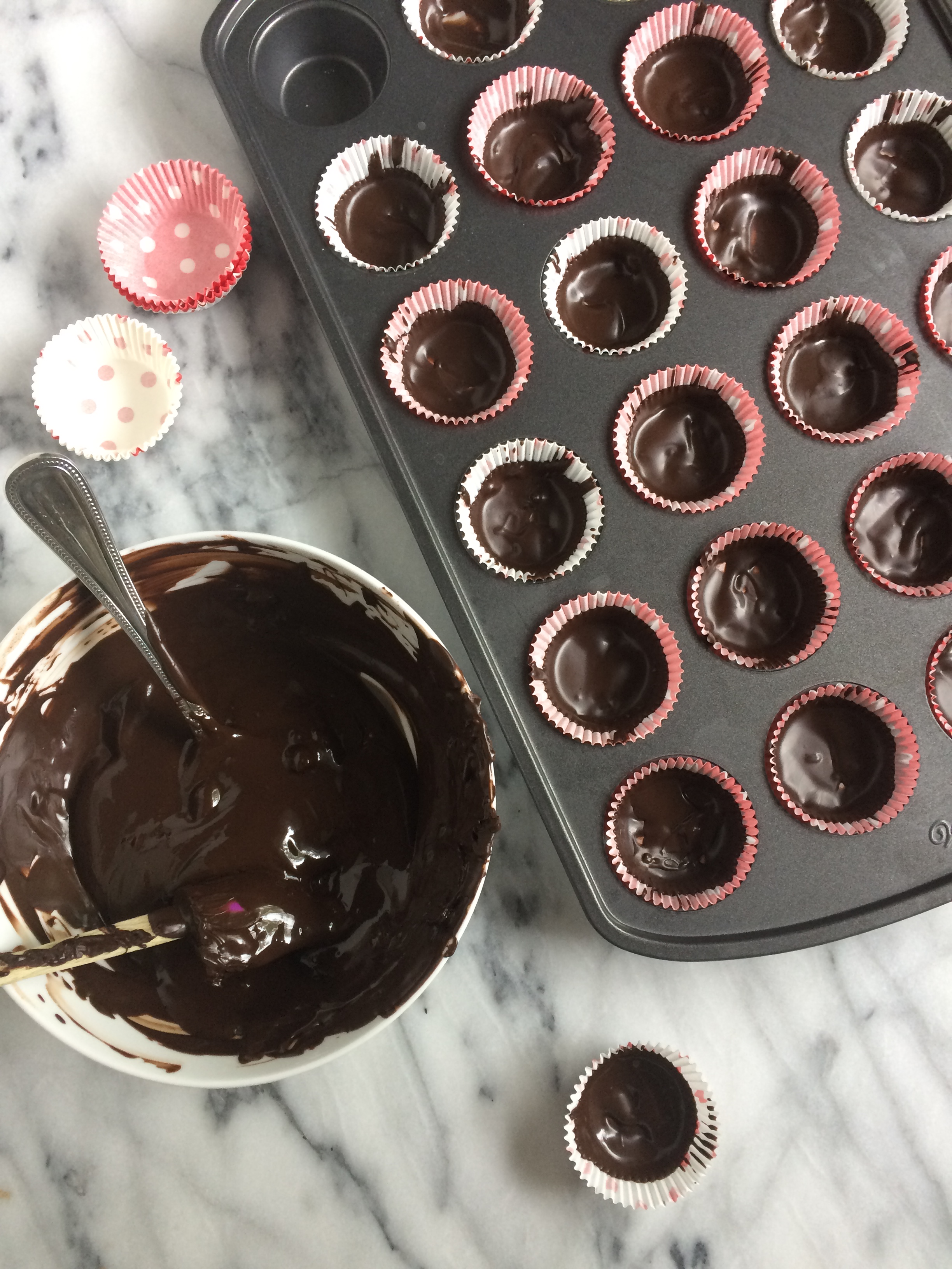 first layer of chocolate spread out in muffin liners