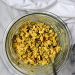 mixing all-yogurt curry chicken salad in a bowl