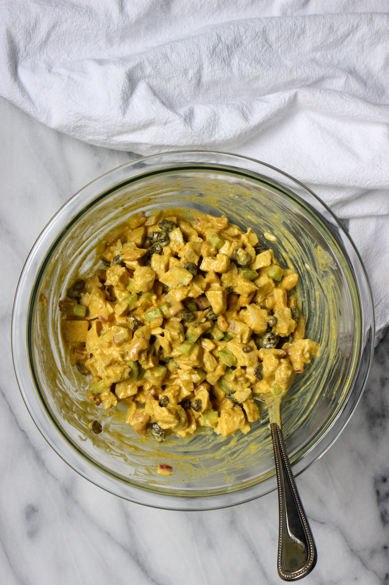 mixing all-yogurt curry chicken salad in a bowl
