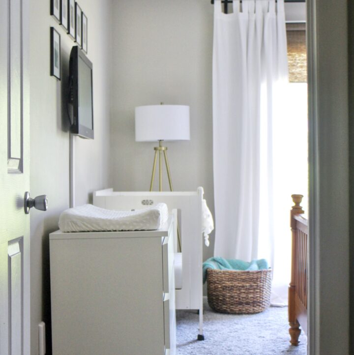 dresser and mini crib across from bed in shared nursery and master