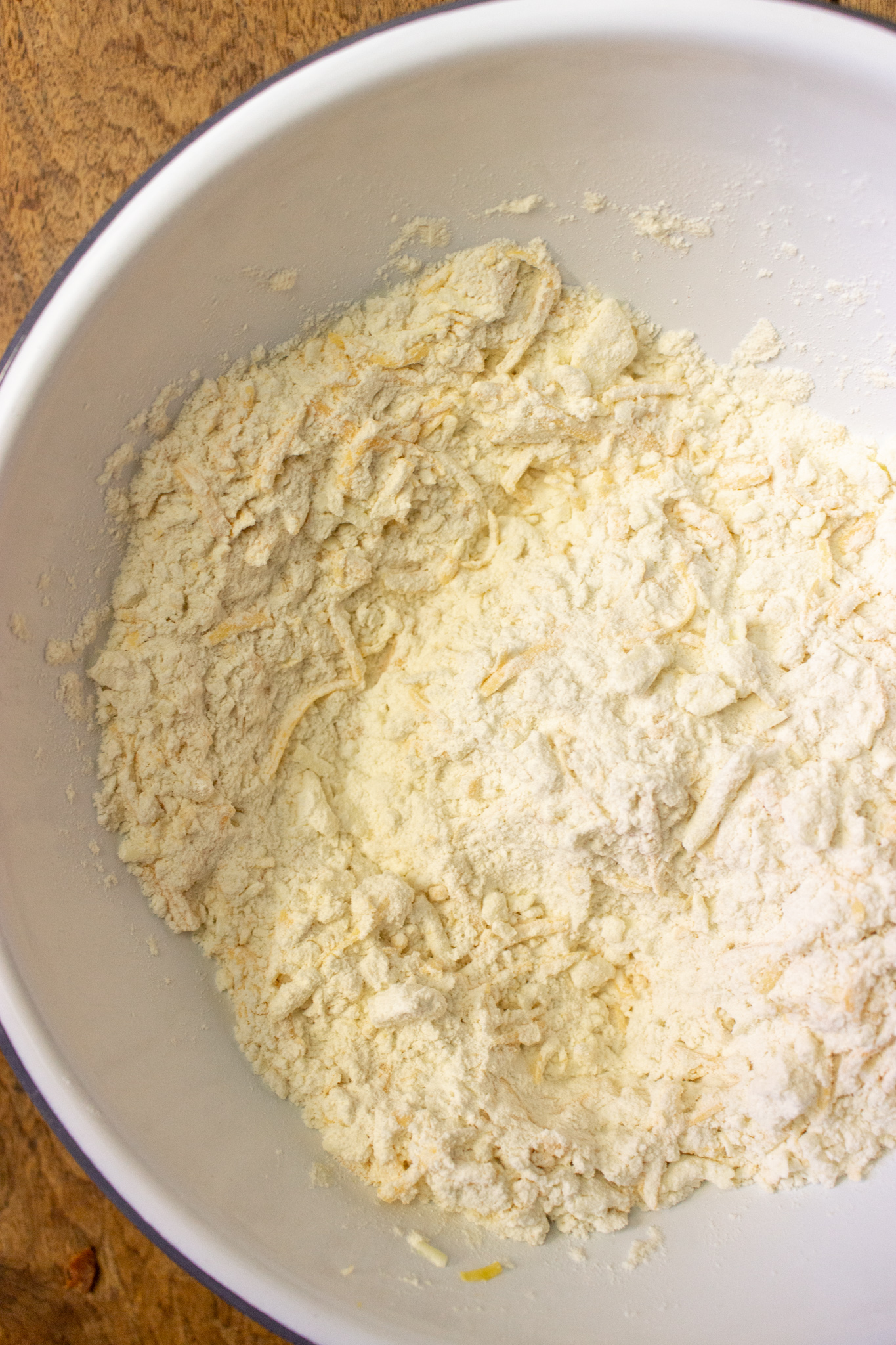 butter and cheese mixed into flour for biscuits