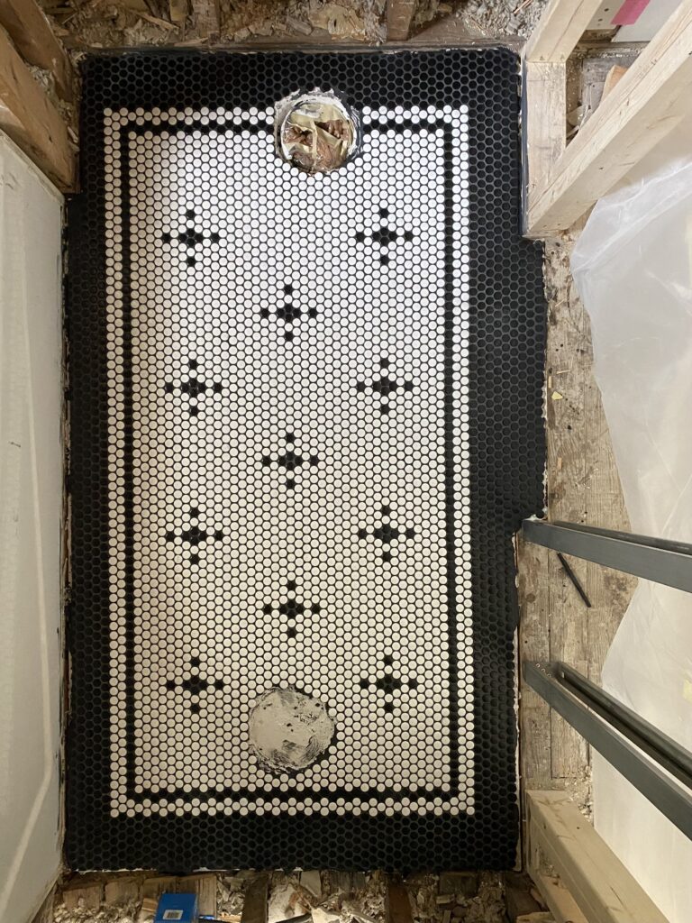 black and white patterned penny tile bathroom floor